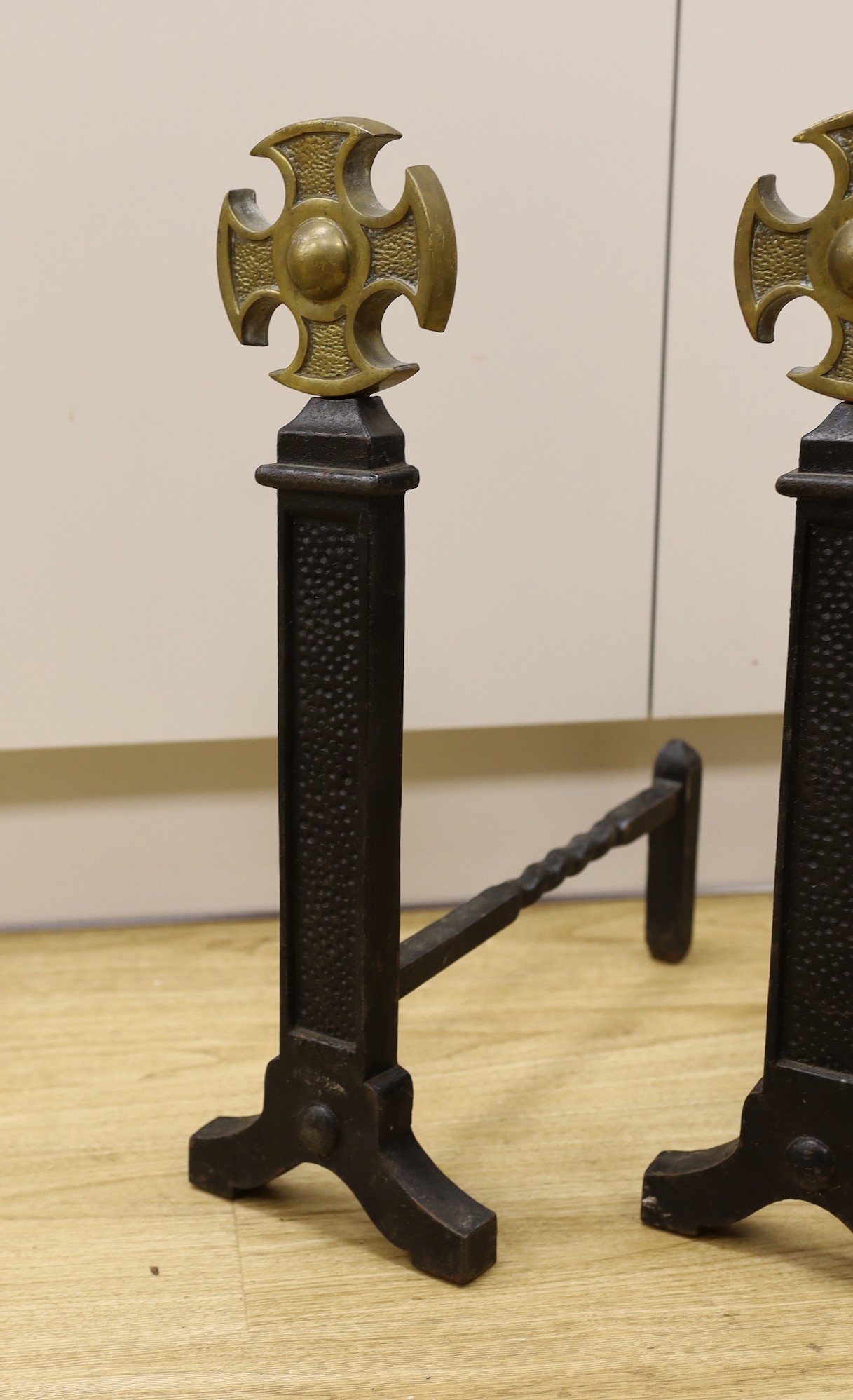 A pair of Victorian cast iron and brass fire dogs, 54cm tall